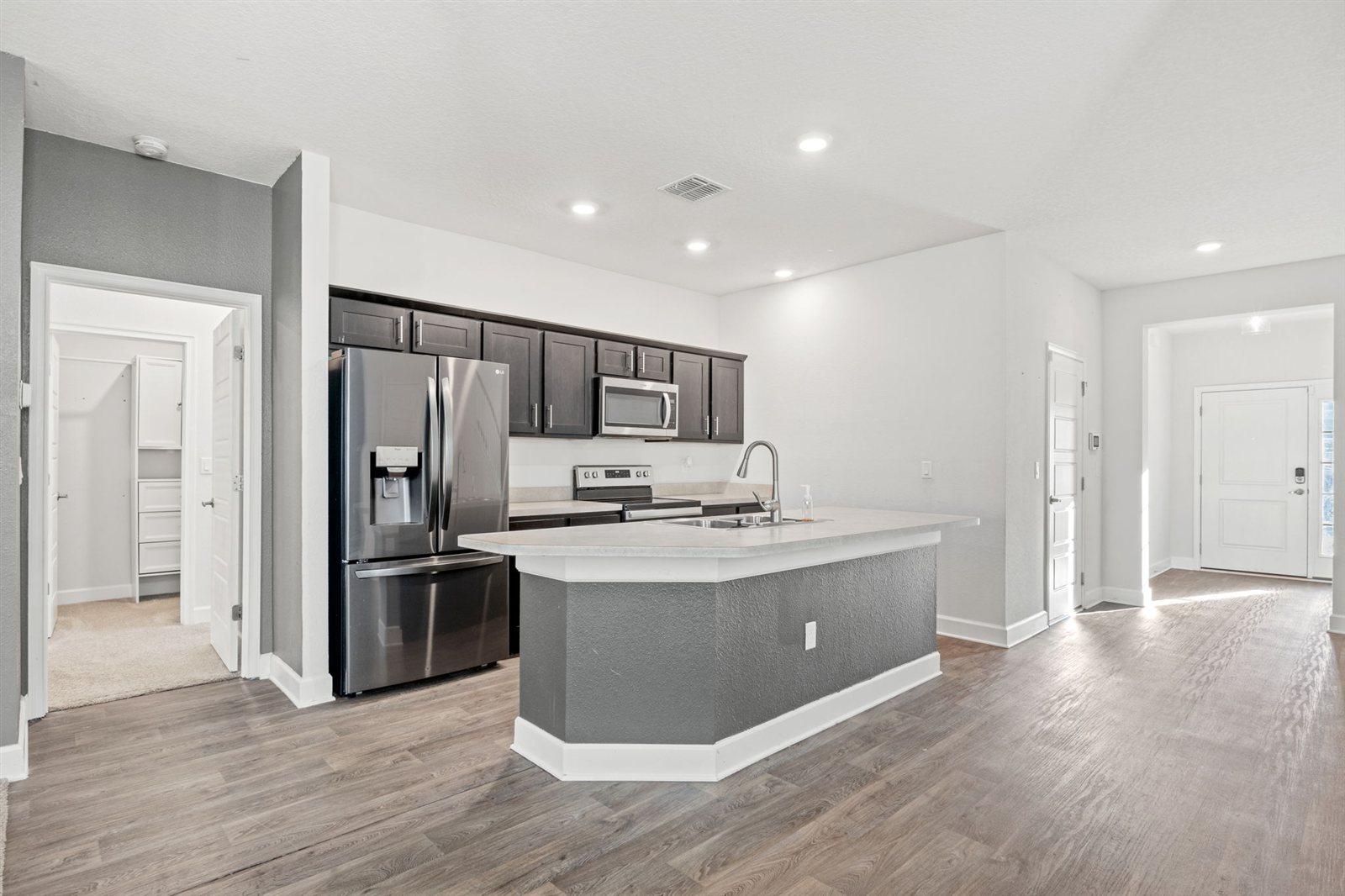 Kitchen island and stainless steel appliances at 9956 Redfish Marsh Cir, Jacksonville FL