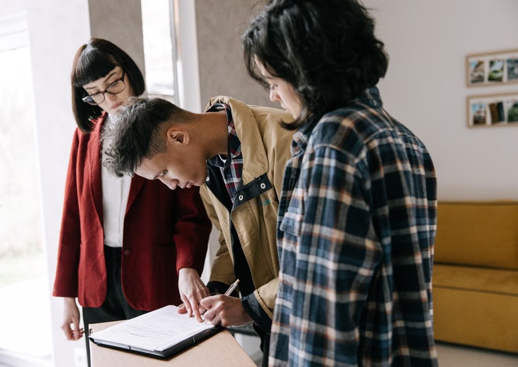 A couple reviewing documents with a real estate professional
